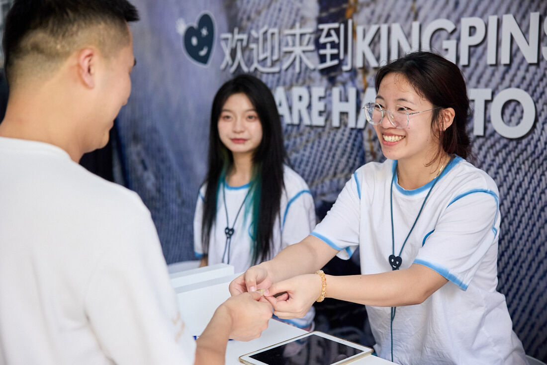 Event photographer coverage of the registration desk welcoming visitors at a Hangzhou exhibition